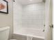 Clean bathroom with white tile, bathtub, and toilet at 7200 N Ocean Blvd. # 765, Myrtle Beach, SC 29572