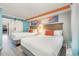 Two double beds in a bright bedroom with ocean-themed art at 7200 N Ocean Blvd. # 765, Myrtle Beach, SC 29572