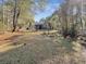 House and large backyard with lush green grass and trees at 786 Savannah Dr., Pawleys Island, SC 29585