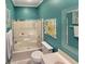Clean bathroom with shower/tub combo and teal colored walls at 786 Savannah Dr., Pawleys Island, SC 29585