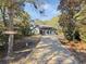 Welcoming home with a gray exterior, and a long driveway, nestled in a wooded area at 786 Savannah Dr., Pawleys Island, SC 29585