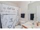 Bright bathroom with golf themed shower curtain, neutral walls and a vanity sink at 820 Fairway Dr. # 1605, Longs, SC 29568