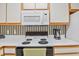 Close-up of the kitchen with white countertops, electric cooktop, microwave and coffee maker at 820 Fairway Dr. # 1605, Longs, SC 29568
