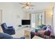 Bright living room featuring a ceiling fan, neutral carpet, and sliding glass doors to a patio at 820 Fairway Dr. # 1605, Longs, SC 29568