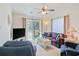 Bright living room featuring a ceiling fan, neutral carpet, and sliding glass doors to a patio at 820 Fairway Dr. # 1605, Longs, SC 29568