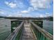 Wooden dock with benches overlooking calm water at 88 Salt Marsh Circle # 22H, Pawleys Island, SC 29585