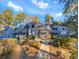 Gray condo building with multiple units, surrounded by lush landscaping at 88 Salt Marsh Circle # 22H, Pawleys Island, SC 29585