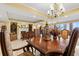 Elegant dining room features a chandelier, fireplace, and large wood table at 9547 Edgerton Dr. # 904, Myrtle Beach, SC 29572