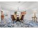 The dining room is decorated with wicker chairs, a modern glass table, and a scenic painting at 9547 Edgerton Dr. # 904, Myrtle Beach, SC 29572
