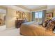 Relaxing main bedroom with dresser, a large window, and a decorative bed at 9547 Edgerton Dr. # 904, Myrtle Beach, SC 29572