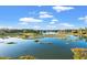 A scenic shot of marsh and a golf course under a blue sky dotted with fluffy clouds at 9547 Edgerton Dr. # 904, Myrtle Beach, SC 29572