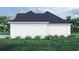White farmhouse exterior side view showcasing the roofline and landscaping at 2180 Pettus Way, Surfside Beach, SC 29575