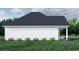 White farmhouse exterior side view showcasing the roofline and landscaping at 2180 Pettus Way, Surfside Beach, SC 29575