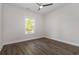 Bright bedroom featuring luxury vinyl plank flooring, a ceiling fan, and a window at 1033 Pisgah Church Rd., Aynor, SC 29511
