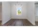 Empty dining room with hardwood floors, a window, and a hanging light fixture at 1033 Pisgah Church Rd., Aynor, SC 29511