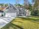 Gray house with white garage doors and a well-manicured lawn at 1033 Pisgah Church Rd., Aynor, SC 29511