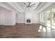 Bright living room features a fireplace, ceiling fan, and sliding glass doors at 1033 Pisgah Church Rd., Aynor, SC 29511
