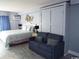 King bed, sofa bed, and wall-mounted storage at 1207 S Ocean Blvd. # 20207, Myrtle Beach, SC 29577
