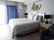 King-size bed, ocean-themed decor, and balcony access at 1207 S Ocean Blvd. # 20207, Myrtle Beach, SC 29577