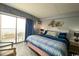 King-size bed, ocean view, and balcony access at 1207 S Ocean Blvd. # 20207, Myrtle Beach, SC 29577