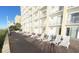 White lounge chairs on a brick patio at 1207 S Ocean Blvd. # 20207, Myrtle Beach, SC 29577
