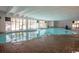 Indoor pool with lounge chairs and large windows at 1207 S Ocean Blvd. # 20207, Myrtle Beach, SC 29577