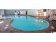 Kidney-shaped indoor pool with brick deck and lounge chairs at 1207 S Ocean Blvd. # 20207, Myrtle Beach, SC 29577