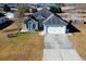 Aerial view of a charming house with a driveway and grassy yard at 130 Lions Paw Ct., Loris, SC 29569