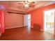 Bedroom with hardwood floors, peach walls, and access to the bathroom at 130 Lions Paw Ct., Loris, SC 29569