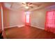 Simple bedroom with hardwood floors, coral walls, and ceiling fan at 130 Lions Paw Ct., Loris, SC 29569