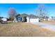 Exterior view of a lovely house with a garage and well-maintained lawn at 130 Lions Paw Ct., Loris, SC 29569