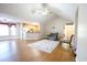 Open living room with hardwood floors, kitchen island, and vaulted ceiling at 130 Lions Paw Ct., Loris, SC 29569