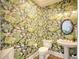 Powder room with unique floral wallpaper and oval mirror at 150 Black Water Dr., Murrells Inlet, SC 29576