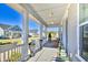 Inviting front porch features a swing and planters at 150 Black Water Dr., Murrells Inlet, SC 29576