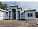 New construction home featuring a grand entrance with modern architecture, neutral paint, and a spacious lot at 1526 Bellini Ct., Myrtle Beach, SC 29579