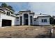 New construction home featuring a grand entrance with modern architecture, neutral paint, and a spacious lot at 1526 Bellini Ct., Myrtle Beach, SC 29579