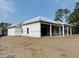 New construction home featuring a covered porch, an attached garage, and first layer of siding at 1526 Bellini Ct., Myrtle Beach, SC 29579