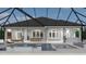 Inviting outdoor space with a pool, screened enclosure, seating, dining area, and lush landscaping at 1526 Bellini Ct., Myrtle Beach, SC 29579