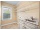 Laundry room featuring sink, granite countertops, cabinets and a window at 2000 Hideaway Point, Myrtle Beach, SC 29579