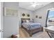 Cozy bedroom with wood framed bed and window seating at 2083 Silver Island Way, Murrells Inlet, SC 29576