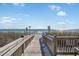 Wooden boardwalk leads to sandy beach at 210 75Th Ave N # 4011, Myrtle Beach, SC 29572