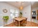 Cozy dining area with a wood table and four chairs, near kitchen at 2102 Hawksmoor Dr., Conway, SC 29526