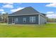 Home's back exterior, featuring a screened porch at 216 William Nobles Rd., Aynor, SC 29511