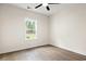 Bright bedroom with wood-look floors, ceiling fan, and large window at 224 William Nobles Rd., Aynor, SC 29511