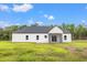 White house with gray roof, screened porch and grassy yard at 224 William Nobles Rd., Aynor, SC 29511