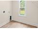 Laundry room with window, vinyl flooring, and built-in shelving at 224 William Nobles Rd., Aynor, SC 29511