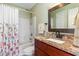 Bathroom featuring a shower and a vanity with granite countertop and dark wood cabinet at 234 Sugar Mill Loop, Myrtle Beach, SC 29588