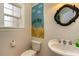 Charming half bathroom with a palm tree mural and decorative mirror at 234 Sugar Mill Loop, Myrtle Beach, SC 29588