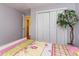 Bright bedroom with colorful bedding, white closet doors, and a charming decorative tree at 234 Sugar Mill Loop, Myrtle Beach, SC 29588