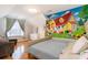 Bright bedroom featuring a whimsical wall mural, hardwood floors, and a cozy seating area at 234 Sugar Mill Loop, Myrtle Beach, SC 29588